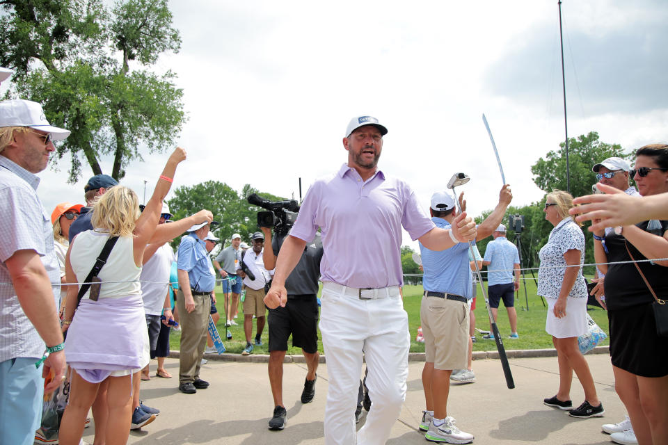 Michael Block walks in front of huge galleries at the Charles Schwab Challenge