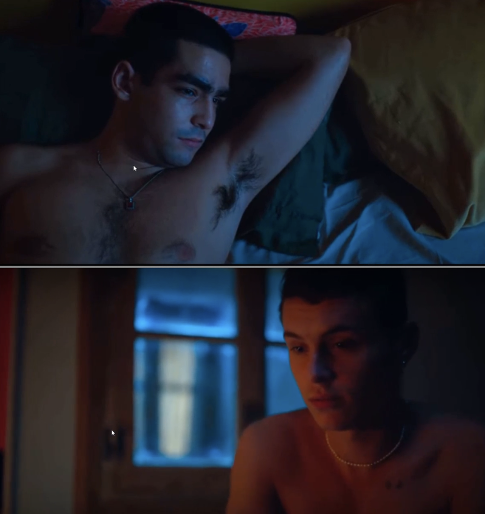 Two shirtless individuals in moody lighting, one lying down and looking up, the other sitting and looking pensive, possibly in a bedroom setting