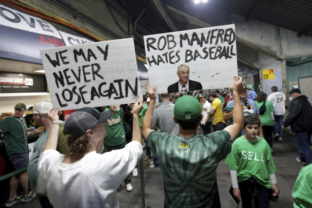 MLB video crops out A's fans' John Fisher protest signs