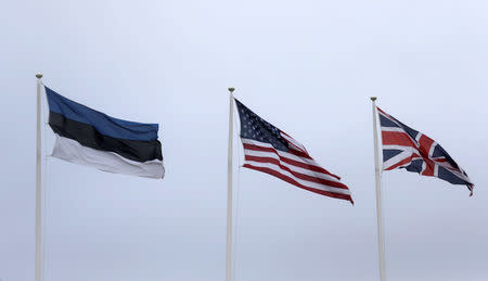 Flags of Estonia, the U.S. and Britain flutter in the Estonian army base in Tapa, Estonia February 16, 2017. REUTERS/Ints Kalnins