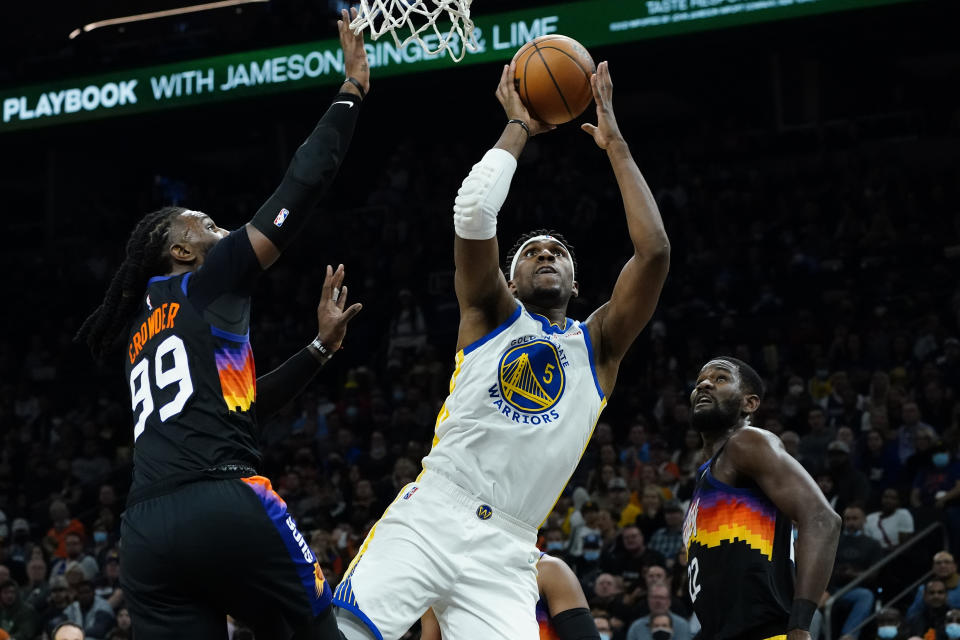 Golden State Warriors center Kevon Looney (5) shoots over Phoenix Suns forward Jae Crowder (99) during the first half of an NBA basketball game, Tuesday, Nov. 30, 2021, in Phoenix. (AP Photo/Matt York)