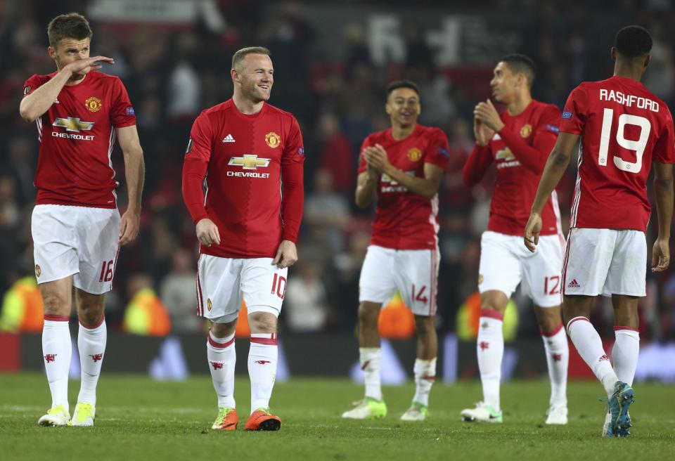 <p>Manchester United’s Wayne Rooney, second left celebrates with teammates after the end of the Europa League semifinal second leg soccer match between Manchester United and Celta Vigo at Old Trafford </p>