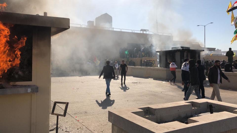 Dozens of Iraqi Shiite militia supporters are seen at the U.S. embassy compound where a fire was set to a reception area, in Baghdad, Iraq, Tuesday, Dec. 31, 2019. (Photo: Qassim Abdul-Zahra/AP)