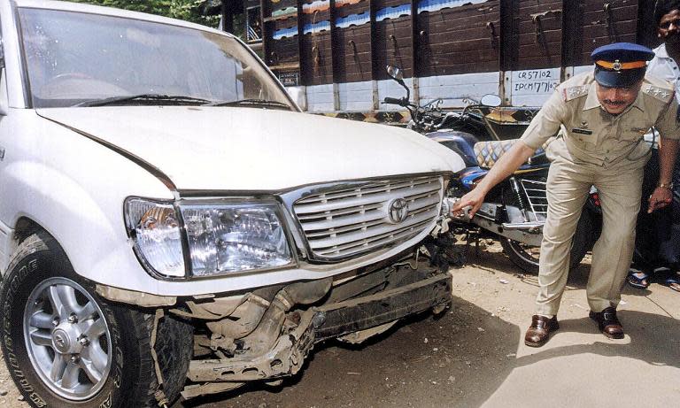 Indian police inspect the Toyota Land Cruiser belonging to Bollywood actor Salman Khan that was involved in the fatal 2002 hit-and-run incident in Mumbai