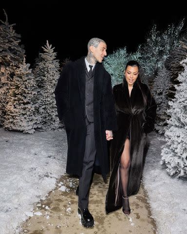 <p>Kourtney Kardashian/Instagram</p> Kourtney Kardashian and Travis Barker at the Kardashian-Jenner Christmas Eve party