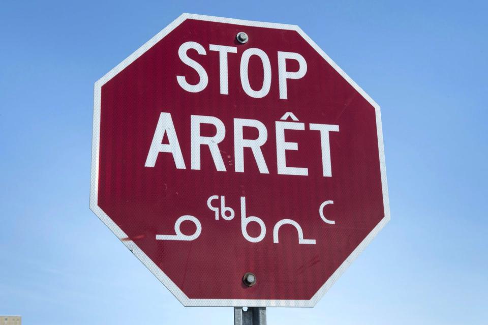 Stop sign reads STOP in english, french and Inuktitut