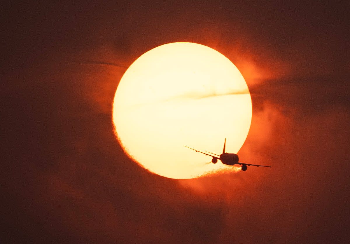 A plane passes in front of the sun on a hazy evening as smoke from wildfires in Canada cause hazy conditions in Washington, DC, on June 7, 2023 (AFP via Getty Images)