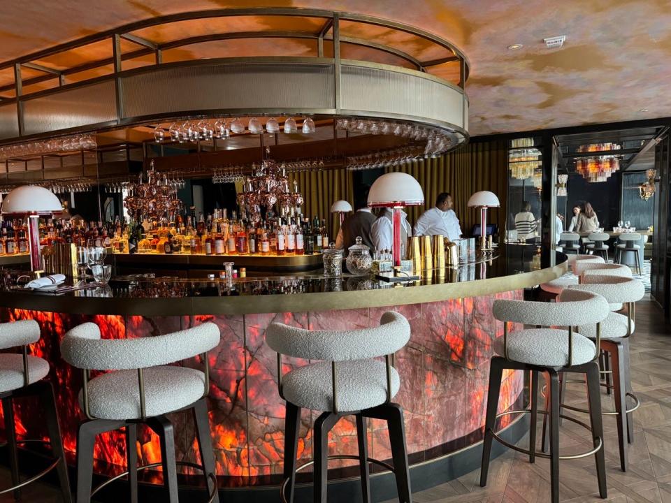 Stools around a lit-up round bar