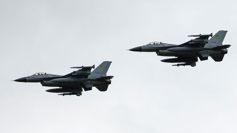 Ukrainian F-16 fighting aircrafts are seen in the air during marking the Day of the Ukrainian Air Forces, in an undisclosed location, Ukraine, August 4, 2024. - Valentyn Ogirenko/Reuters