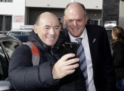 FILE - In this Thursday July 9, 2020 file photo, leader of New Zealand's opposition National Party, Todd Muller, poses for a selfie with a supporter outside a hotel in Christchurch, New Zealand. Muller has quit Tuesday, July 14, 2020, citing health reasons just over two months from a general election and 53 days after taking charge in a leadership coup amid the party's stagnant poll numbers. (AP Photo/Mark Baker,File)