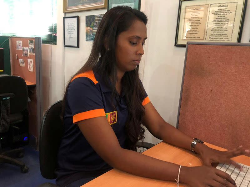 Namal Ishari, who was affected by 2004 tsunami and who now works as a team leader at a business process outsourcing unit for Sri Lankan conglomerate John Keells Holdings, is seen at work in Seenigama village, Sri Lanka