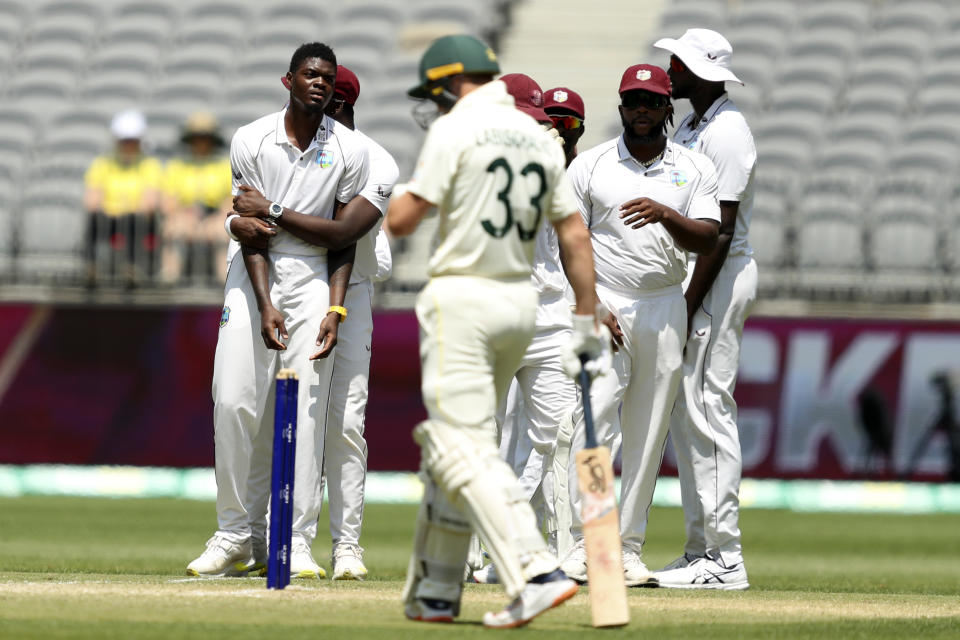 West Indies' Alzarri Joseph, left, watches as Australia's Marnus Labuschagne, front, returns after his dismissal was overturned on a no-ball from Joseph on the 3rd day of their cricket test in Perth, Australia, Saturday, Dec. 3, 2022. (AP Photo/Gary Day)