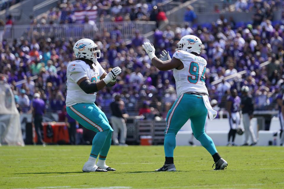 Dolphins defensive tackle Christian Wilkins (94) celebrates a fumble recovery with Robert Hunt during the first half of Sunday's game.