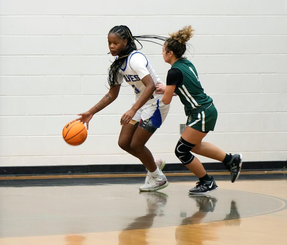 Deltona's Calise Chisholm attempts to drive past Flagler Palm Coast's Ava Works during a game at Atlantic High School, Saturday, Jan. 20, 2024.