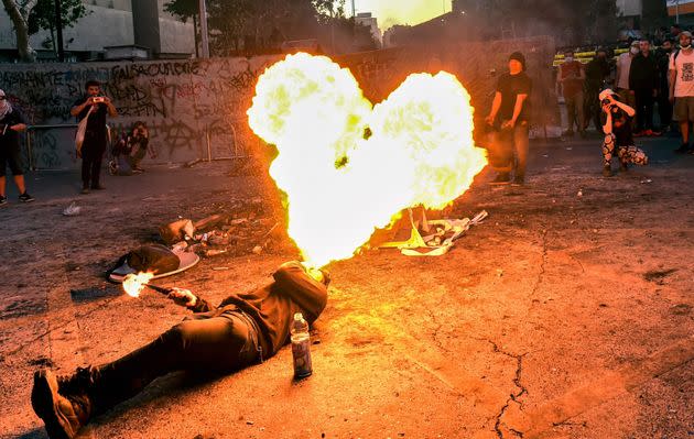 A protester spits fire during a protest to mark the second anniversary of an uprising against social inequality, in Santiago, Chile, on Oct.18.   (Photo: MARTIN BERNETTI/AFP via Getty Images)