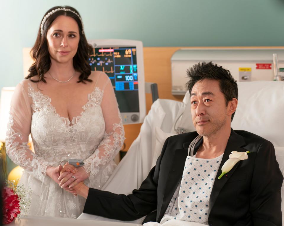 Maddie (Jennifer Love Hewitt, left) and Chimney (Kenneth Choi) enter into holy matrimony in the comfort of a hospital room.