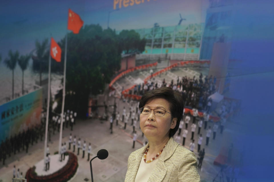 Hong Kong Chief Executive Carrie Lam listens to a reporter's question during a news conference on the Hong Kong electoral system reform in Hong Kong, March 30, 2021. China's top legislature approved amendments to Hong Kong's constitution on Tuesday that will give Beijing more control over the makeup of the city's legislature. (AP Photo/Kin Cheung)