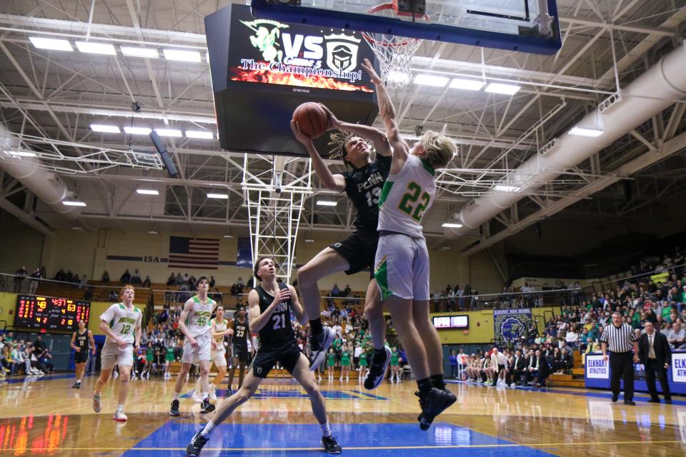 Penn's Dominic Bonner (13) goes up for a shot against Northridge's Mason Bales (22) during the IHSAA Sectional Final Monday, Mar. 6, 2023 at Northside Gym in Elkhart.