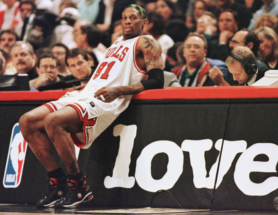 CHICAGO, UNITED STATES:  Dennis Rodman of the Chicago Bulls leans on the scorers table as he waits to come into the game against the Utah Jazz 10 June in game four of the NBA Finals at the United Center in Chicago, IL. Rodman hit four free throws down the stretch to lead the Bulls as they beat the Jazz 86-82 to lead the best-of-seven series 3-1.        AFP PHOTO/Jeff HAYNES  (Photo credit should read JEFF HAYNES/AFP via Getty Images)