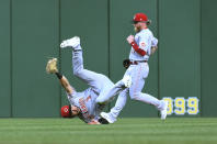 Cincinnati Reds center fielder Albert Almora (3) tumbles after making the catch on a ball hit by Pittsburgh Pirates' Bligh Madris, as right fielder Jake Fraley watches during the third inning of a baseball game, Friday, Aug. 19, 2022, in Pittsburgh. (AP Photo/Philip G. Pavely)