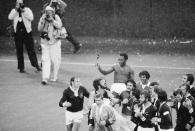 FILE - Pele is carried off the Giants Stadium field by his New York Cosmos teammates after his final soccer game, in East Rutherford, New Jersey, Oct. 1, 1977. Smiling and looking up at Pele are Giorgio Chinaglia of Italy and Erol Yasin of Turkey, center. Pelé, the Brazilian king of soccer who won a record three World Cups and became one of the most commanding sports figures of the last century, died in Sao Paulo on Thursday, Dec. 29, 2022. He was 82. (AP Photo/Bill Kostroun, File)