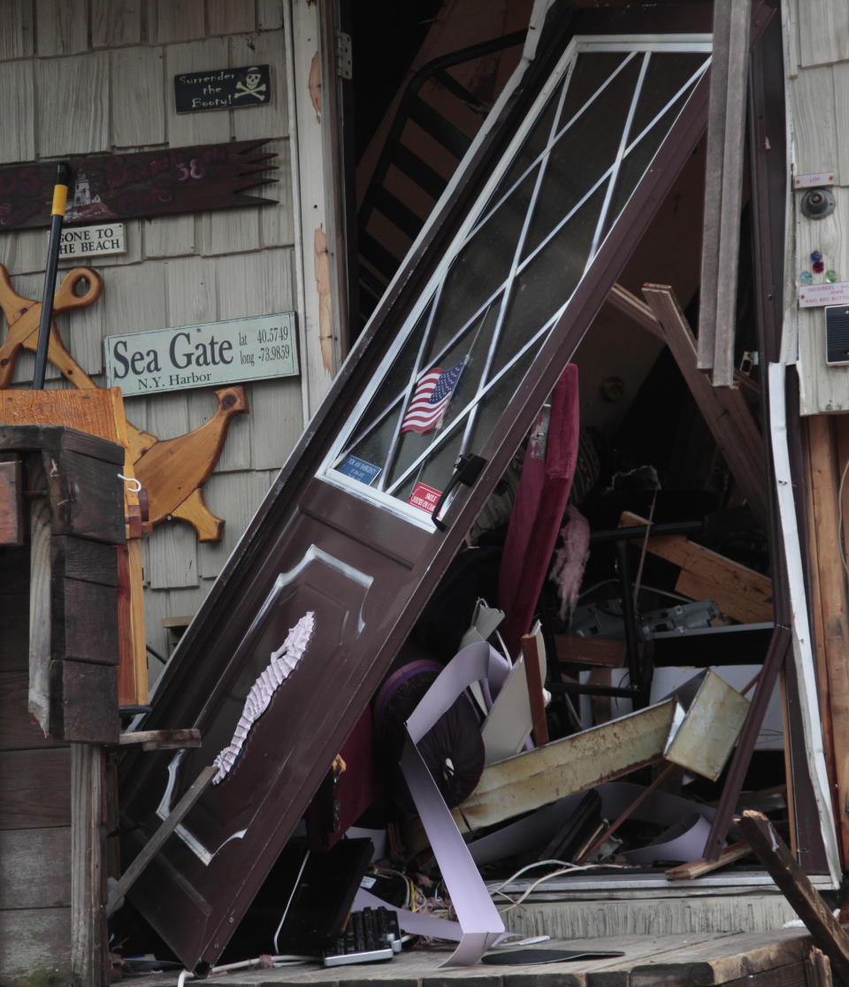 The entrance to a beachfront house is destroyed in the aftermath of a storm surge from superstorm Sandy, Tuesday, Oct. 30, 2012, in Coney Island's Sea Gate community in New York. (AP Photo/Bebeto Matthews)