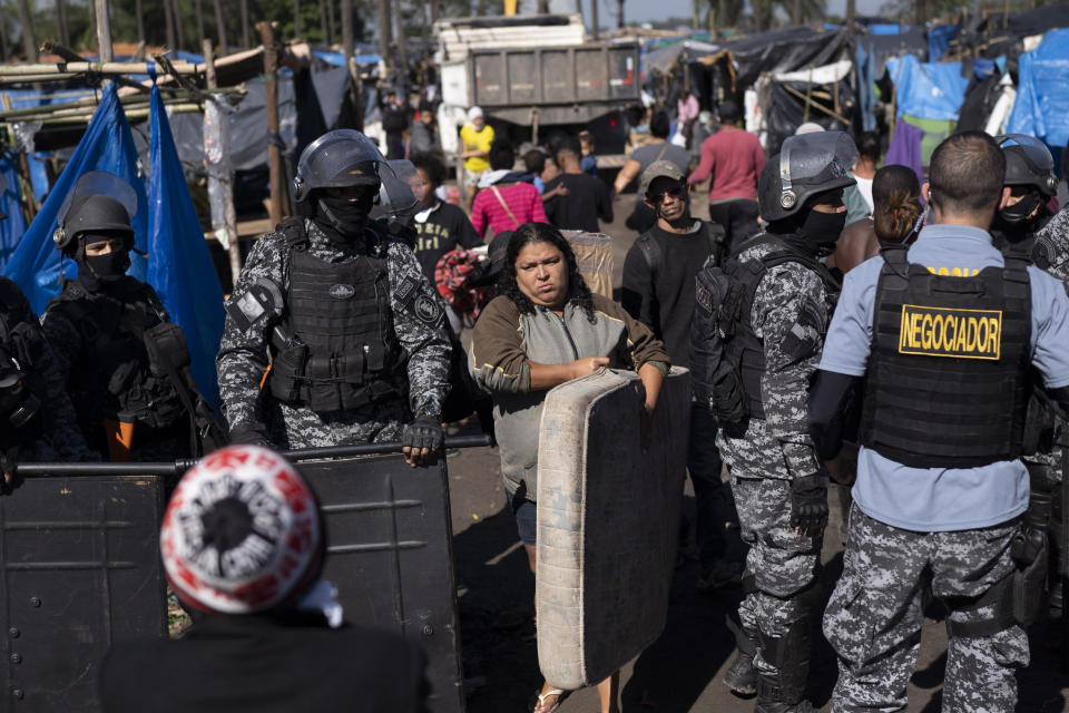 People are evicted from land designated for a Petrobras refinery, at a settlement coined the "First of May Refugee Camp," referring to the date people moved here and set up tents and shacks to live in during the new coronavirus pandemic in Itaguai, Rio de Janeiro state, Brazil, Thursday, July 1, 2021. (AP Photo/Silvia Izquierdo)