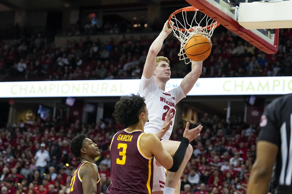 Wisconsin's Steven Crowl (22) dunks next to Minnesota's Pharrel Payne, left, and Dawson Garcia (3) during the second half of an NCAA college basketball game Tuesday, Jan. 3, 2023, in Madison, Wis. (AP Photo/Andy Manis)