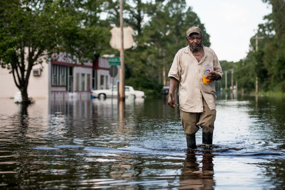 Larry Hickman walks in floodwaters from the Waccamaw River caused by Hurricane Florence on September 26, 2018, in Bucksport, South Carolina. Nearly two weeks after making landfall in North Carolina, river flooding continued after Florence in South Carolina.