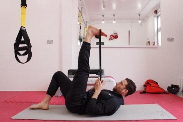 Hamstring stretch, using a resistance band (George Pearse)