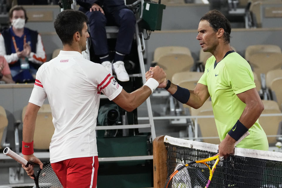 FILE - Serbia's Novak Djokovic, left, shakes hands with Spain's Rafael Nadal after their semifinal match of the French Open tennis tournament at the Roland Garros stadium, Friday, June 11, 2021 in Paris. When Djokovic and Nadal meet in the French Open quarterfinals on Tuesday, May 31, 2022, it will be their 59th career matchup, more than any other two men in the professional era of tennis, and their first showdown since last year's semifinals at Roland Garros. (AP Photo/Michel Euler, Filer)