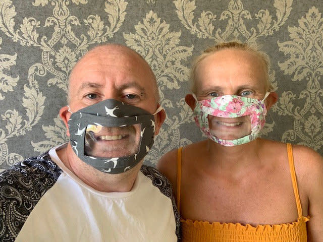 Justine Bate and her husband Carl modelling the masks, which enable deaf people to lip read. (SWNS)