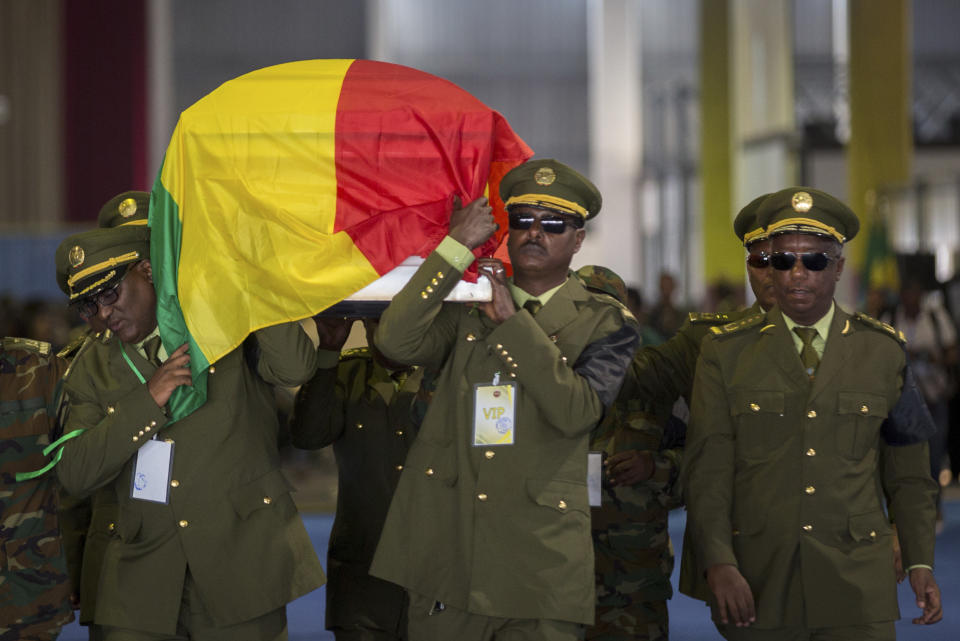 The coffin of assassinated army chief Gen. Seare Mekonnen is taken away for burial after a state ceremony at the Millennium Hall in the capital Addis Ababa, Ethiopia Tuesday, June 25, 2019. Ethiopia's Prime Minister Abiy Ahmed sobbed openly at the service Tuesday for the military chief who was assassinated by his own bodyguard over the weekend. (AP Photo/Mulugeta Ayene)