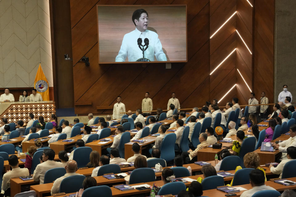 Philippine President Ferdinand Marcos Jr. is shown on an electronic board as he delivers his second state of the nation address at the House of Representatives in Quezon City, Philippines on Monday, July 24, 2023. (AP Photo/Aaron Favila)