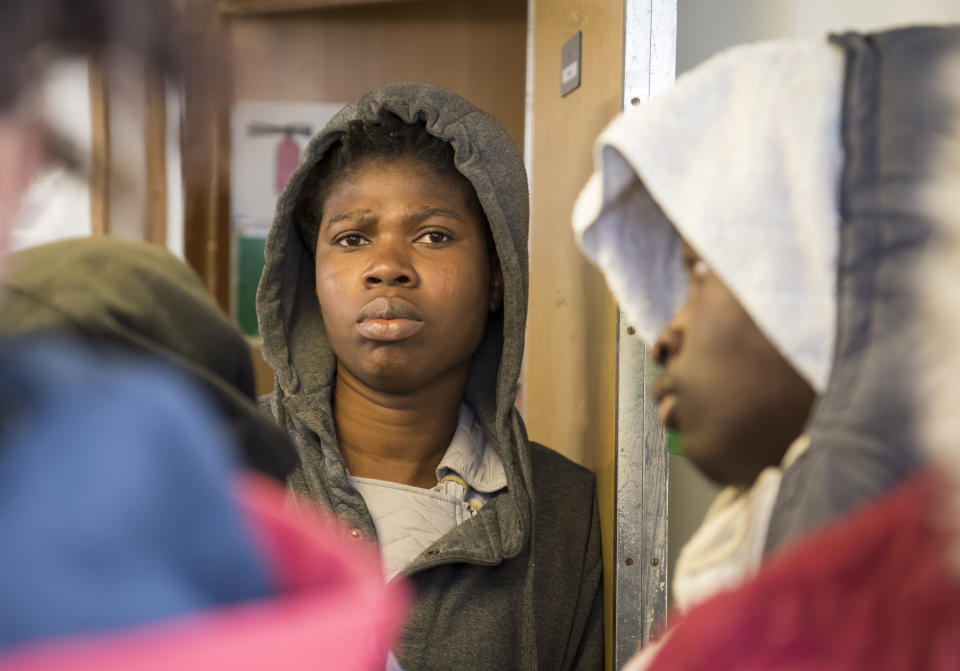 Some of the 17 people rescued in the Mediterranean Sea wait aboard the German rescue ship Sea-Eye afloat off Malta, Tuesday, Jan. 8, 2019. Two German nonprofit groups appealed to European Union countries Tuesday to take in 49 migrants who are stuck on rescue ships in the Mediterranean Sea, warning of the passengers' deteriorating health. (AP Photo/Rene Rossignaud)