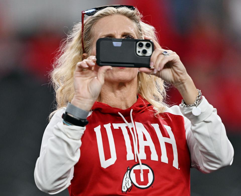 A Utah Utes fan takes photos as Utah and Northwestern prepare to play in the SRS Distribution Las Vegas Bowl on Saturday, Dec. 23, 2023. | Scott G Winterton, Deseret News