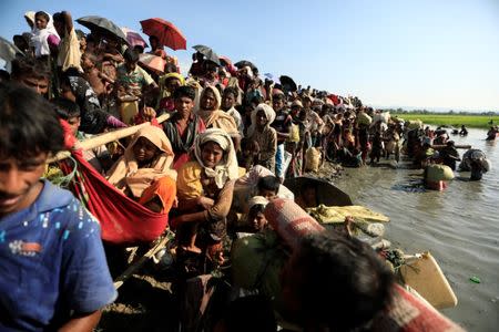 Rohingya refugees who fled from Myanmar wait to be let through by Bangladeshi border guards after crossing the border in Palang Khali, Bangladesh October 16, 2017. REUTERS/ Zohra Bensemra