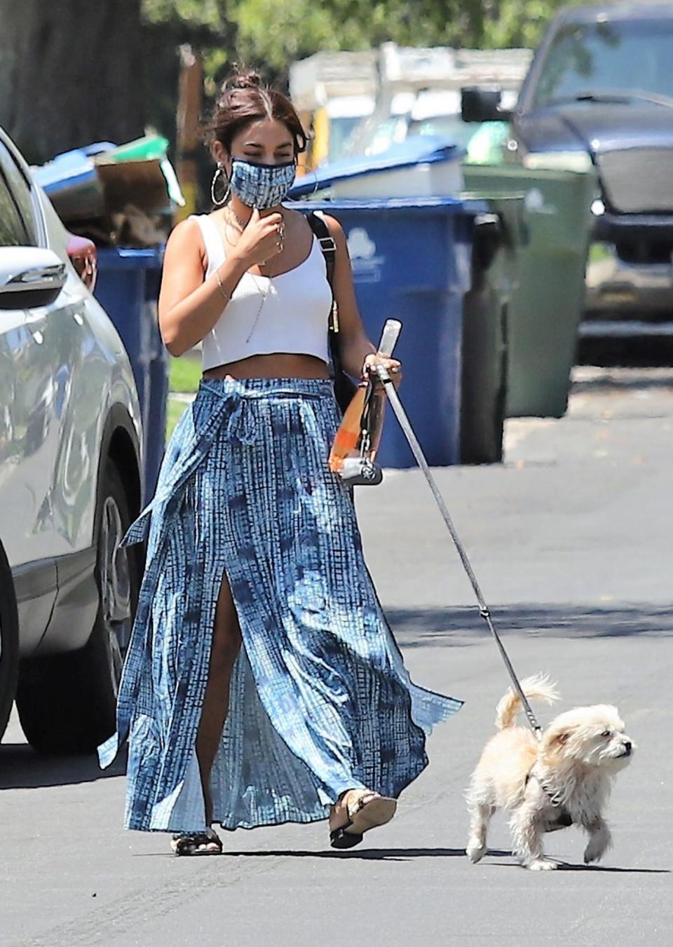 <p>Vanessa Hudgens totes a bottle of rosé on Thursday while going to visit a friend in L.A. with her dog. </p>