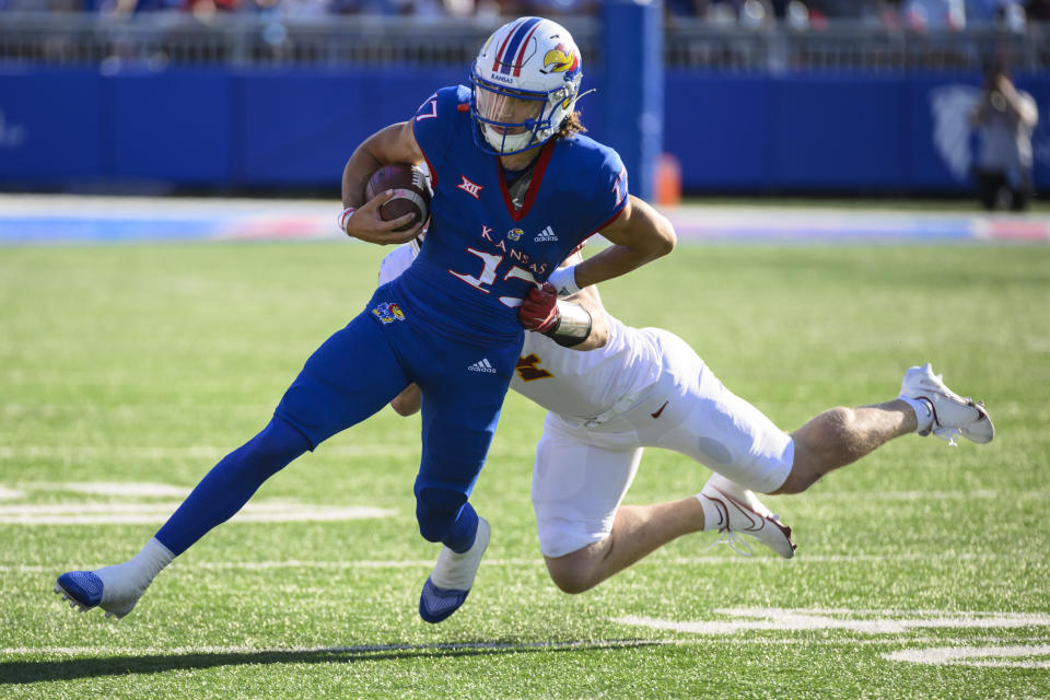 Kansas quarterback Jason Bean (17) is tackled by Iowa State linebacker Colby Reeder (4) during the second half of an NCAA college football game, Saturday, Oct. 1, 2022, in Lawrence, Kan. (AP Photo/Reed Hoffmann)