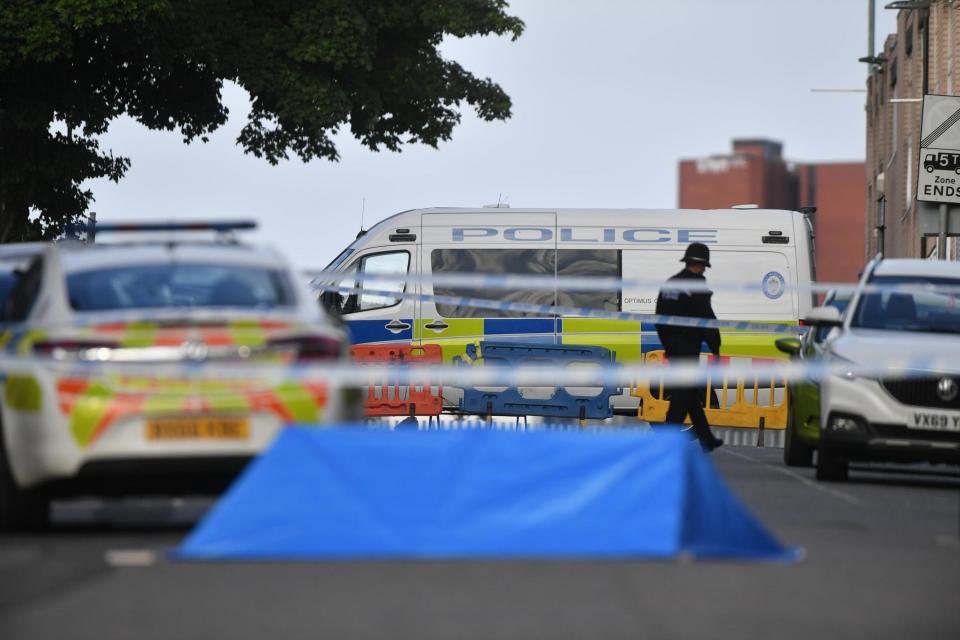 A police officer and vehicles at a cordon in Irving Street in Birmingham after a number of people were stabbed in the city (PA Wire/PA Images)