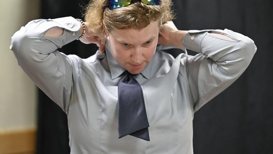 Space Force Maj. Laura Light tries on a uniform necktie during a fitting at the Pentagon Aug. 7. (Eric Dietrich/Air Force)