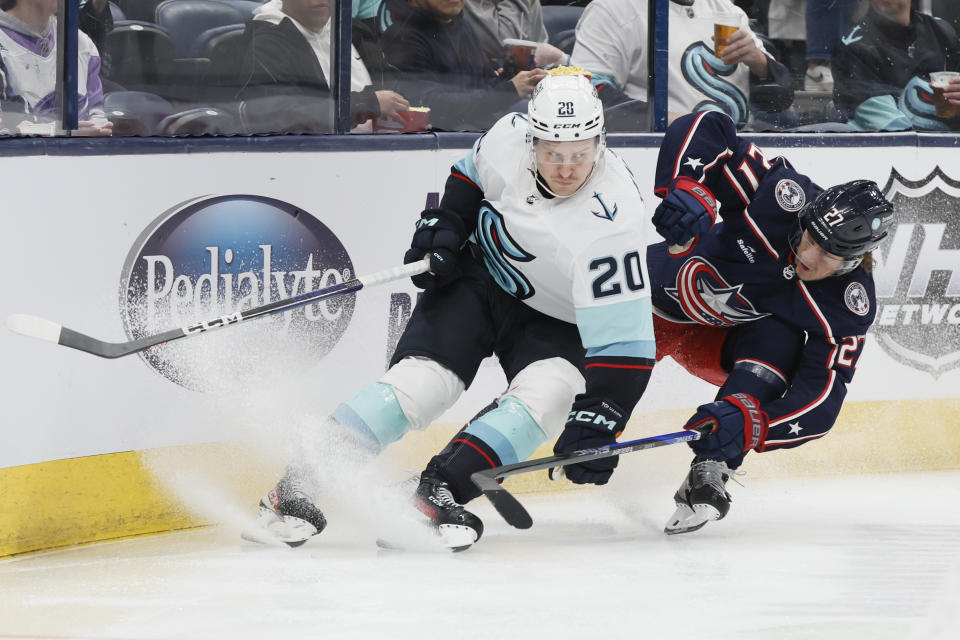 Seattle Kraken's Eeli Tolvanen, left, and Columbus Blue Jackets' Adam Boqvist chase the puck during the first period of an NHL hockey game Friday, March 3, 2023, in Columbus, Ohio. (AP Photo/Jay LaPrete)
