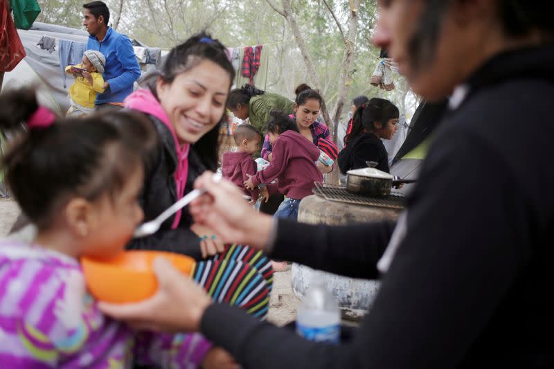 FILE PHOTO: Migrants, mainly asylum seekers sent back to Mexico from the U.S. under the Remain in Mexico program officially named Migrant Protection Protocols (MPP), are seen at provisional campsite near the Rio Bravo in Matamoros