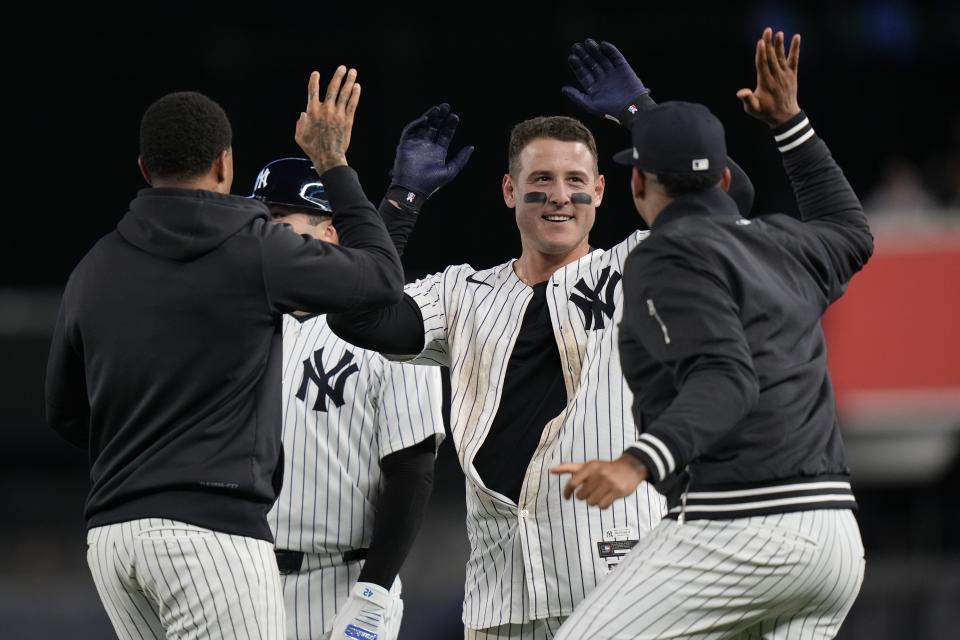 New York Yankees' Anthony Rizzo, center, celebrates with teammates after hitting a walk-off RBI single during the ninth inning of a baseball game against the Detroit Tigers, Friday, May 3, 2024, in New York. The Yankees won 2-1. (AP Photo/Frank Franklin II)