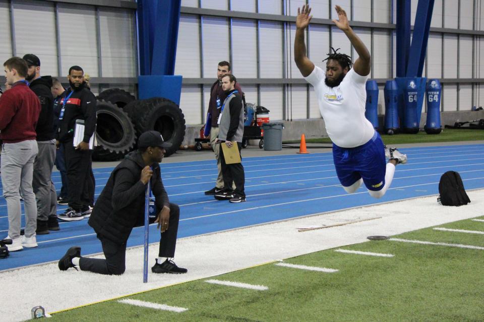 Defensive tackle Thomas Stacker takes flight in the broad jump during Wednesday's South Dakota State football Pro Day in Brookings.