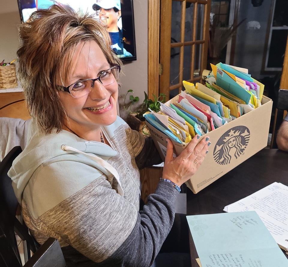 Tammy Brzeczkowski sits at a dining room table with a box full of cards from well-wishers at her home on Oct. 5, 2023 in Pulaski, Wis.
