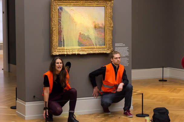 PHOTO: This handout picture released, Oct. 23, 2022, by 'Last Generation' shows activists glued underneath the painting 'Les Meules' by French artist Claude Monet after pouring mashed potatoes on the artwork in the Barberini Museum in Potsdam, Germany. (LAST GENERATION/AFP via Getty Images)