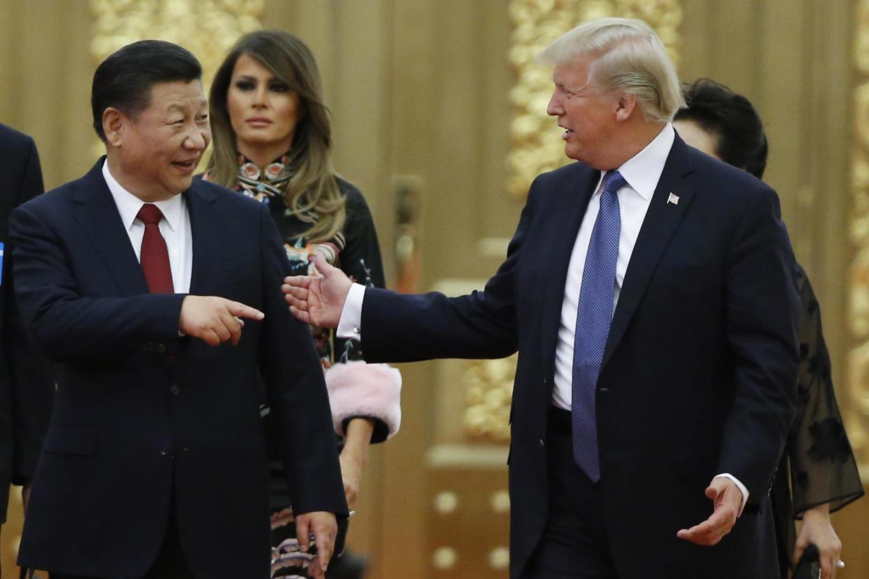 US President Donald Trump and China's President Xi Jinping arrive at a state dinner at the Great Hall of the People: Thomas Peter-Pool/Getty Images