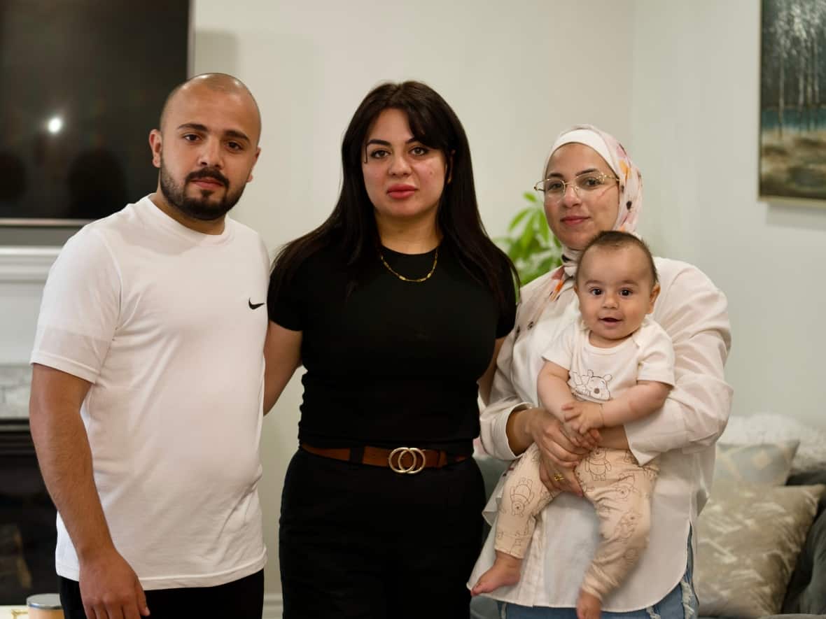 Abeer Abusharar (center) spent months trying to get her brother Oun, his wife Haneen and their son Sanad out of Gaza through Canada's special visa program from extended family. They landed in Montreal on May 6 after evacuating Gaza by paying a $15,000 bribe. (Pierre-Paul Couture/CBC News - image credit)
