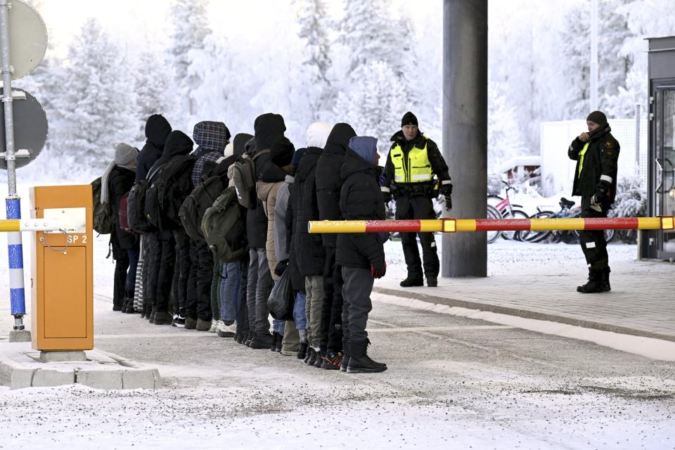 Migrants line up at the international border crossing between Russia and Finland, in Salla, northern Finland, on Wednesday, Nov. 22, 2023. (Jussi Nukari/Lehtikuva via AP)
